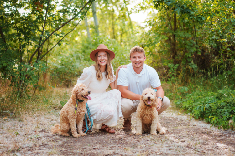 Jessica and Ryan Vineyard with their two dogs in the woods