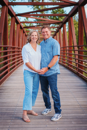 Molli and Chad Vineyard holding hands on a bridge