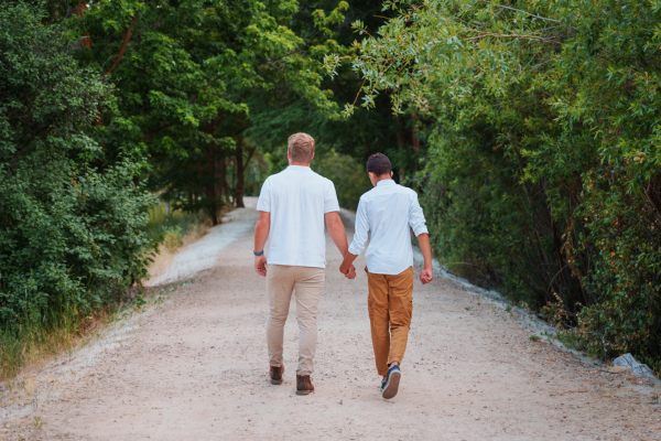Staff member walking with a client down a gravel road surrounded by trees